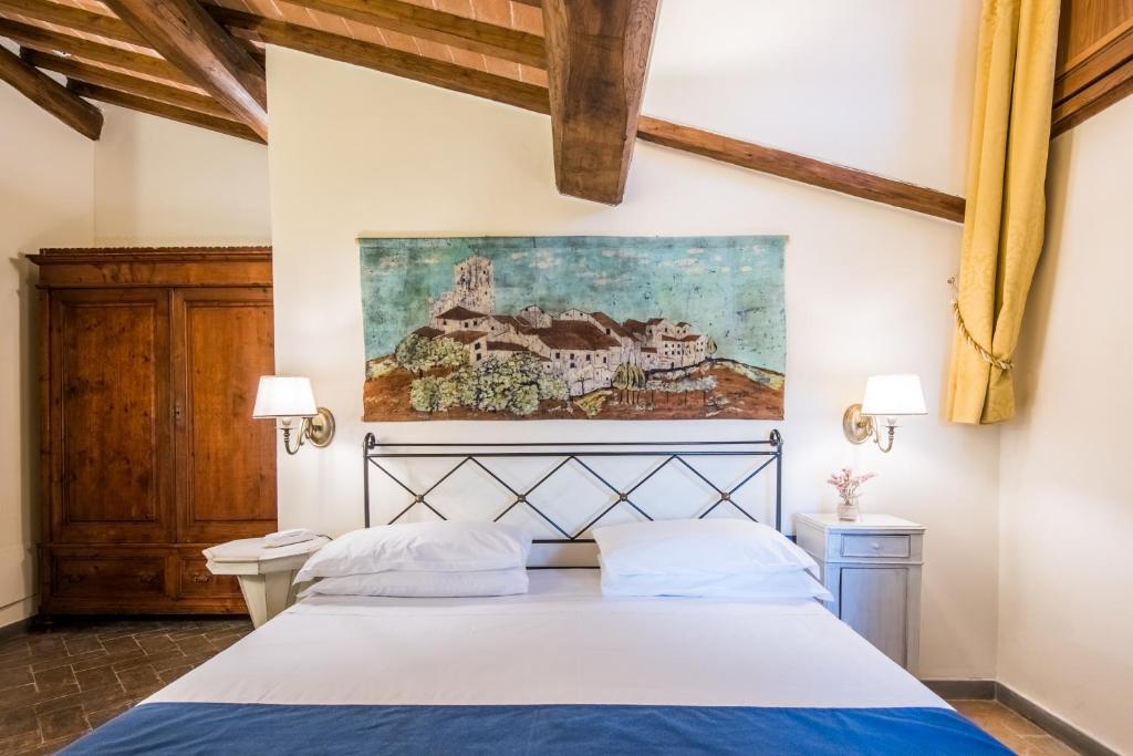 Postel nebo postele na pokoji v ubytování Hotel Palazzo Squarcialupi