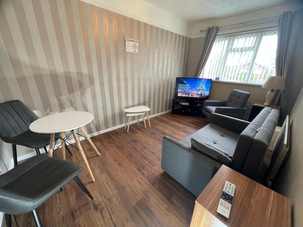 a living room with a couch and a table at Comfy One Bedroom Apartment in Darlaston