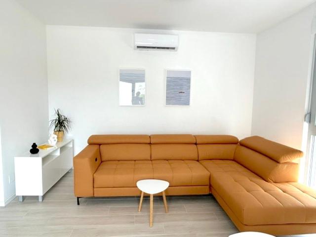 a living room with a brown couch and a chair at Aurus 2 in Korčula