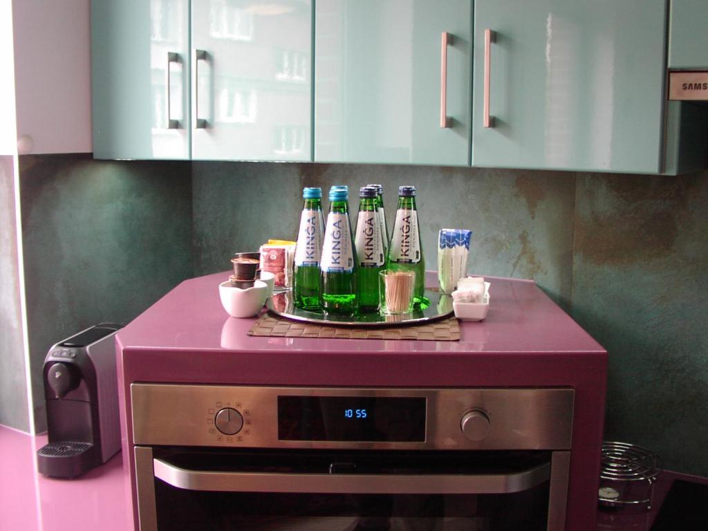 a bunch of bottles sitting on top of a microwave at Planet Gdansk Apartments Mercure Old Nova in Gdańsk