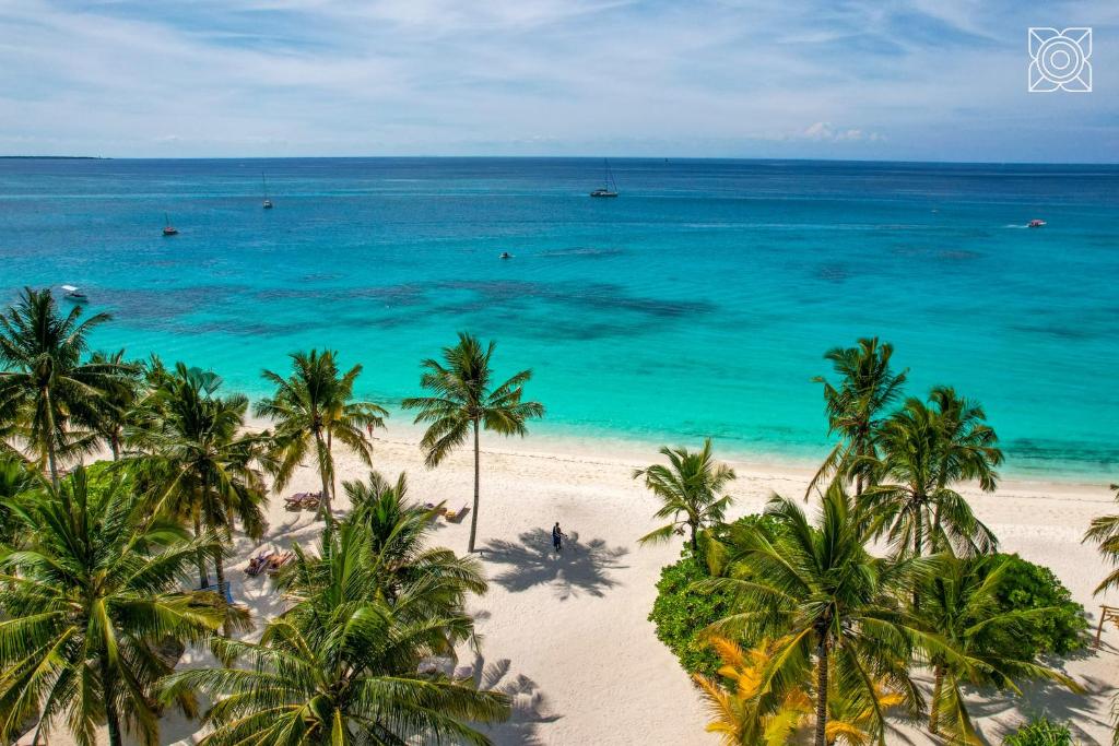 an aerial view of a beach with palm trees and the ocean at Zuri Zanzibar in Kendwa