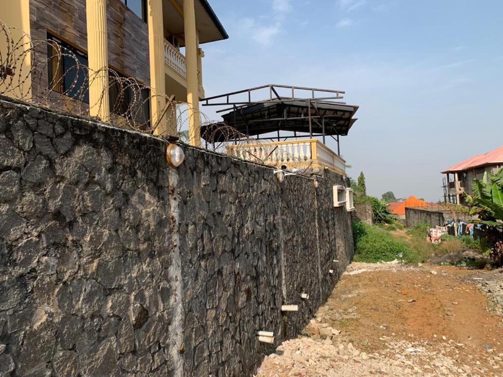 a stone wall with a building on top of it at Luxurious peaceful retreat in Freetown
