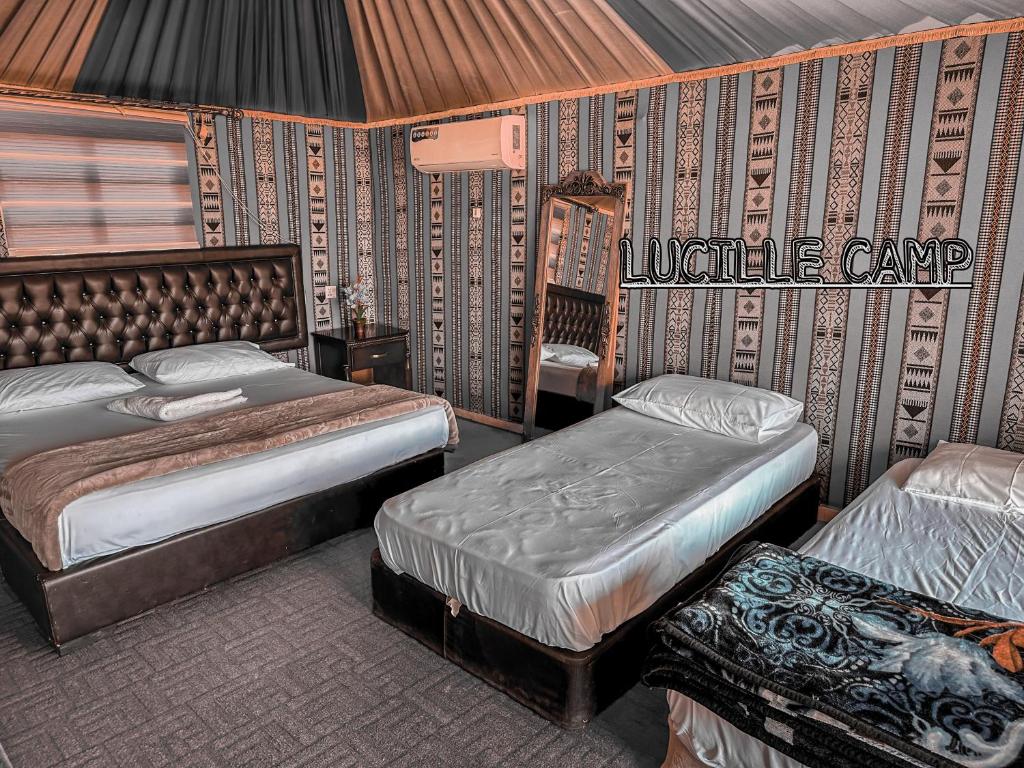 a bedroom with two beds in a room at Rum Lucille Luxury camp in Wadi Rum