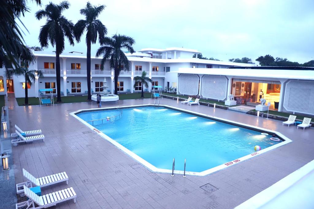 a large swimming pool in front of a building at Hotel Chandela Khajuraho in Khajurāho
