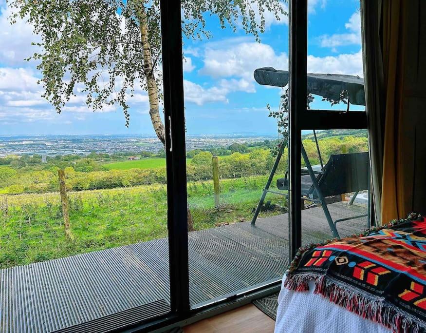 a room with a large window with a view at The Cabin in the Woods in Dublin