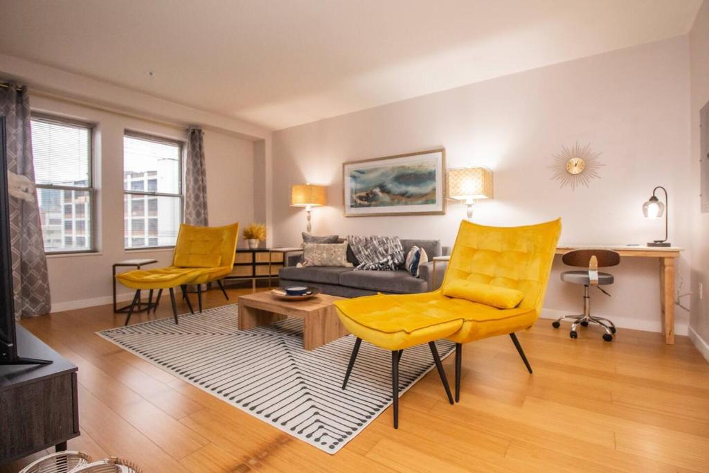 a living room with yellow chairs and a couch at Luxury, 2bed,2 Bath, Boston Central, Boston Univ in Boston