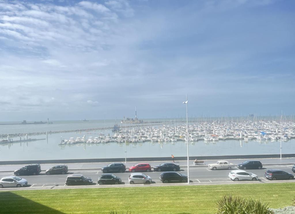 a parking lot with cars parked next to a marina at Vivez le Bonheur - Plage - Port de plaisance - Vue mer in Le Havre