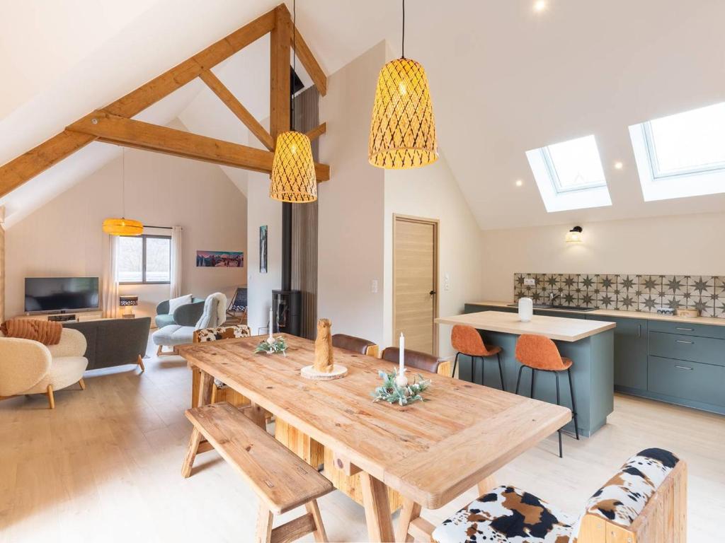 a kitchen and living room with a wooden table at Maison Loudenvielle, 4 pièces, 8 personnes - FR-1-695-47 in Loudenvielle