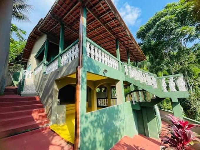 a house with a staircase leading up to it at Pousada e Hostel Vida no Paraiso in Angra dos Reis