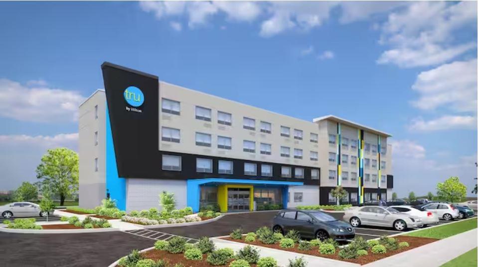 a rendering of a building with cars parked in a parking lot at Tru By Hilton Rogers Bentonville in Rogers