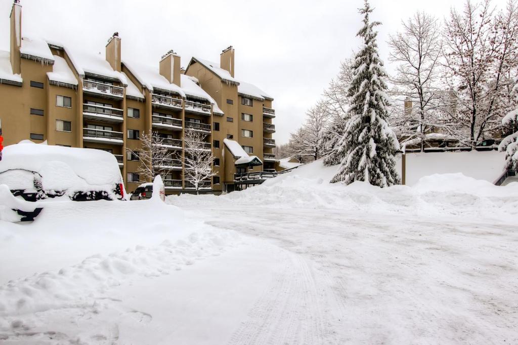 a street covered in snow in front of condos at Mountain Green Condos at Killington in Killington