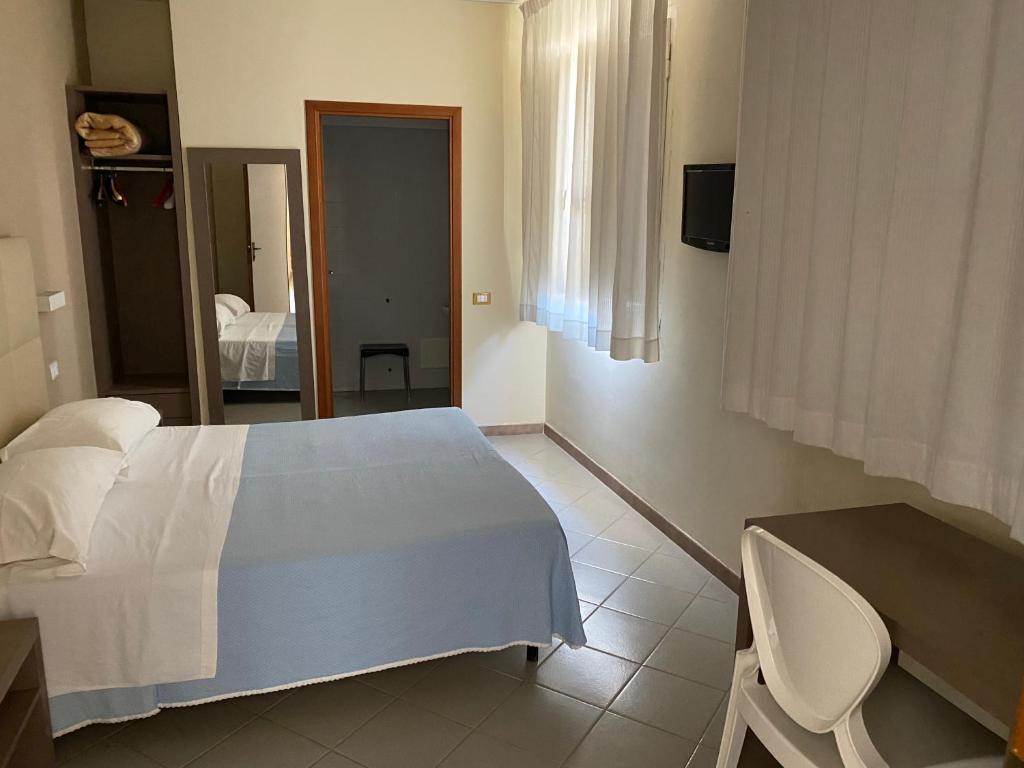 Postel nebo postele na pokoji v ubytování Hotel Moderno
