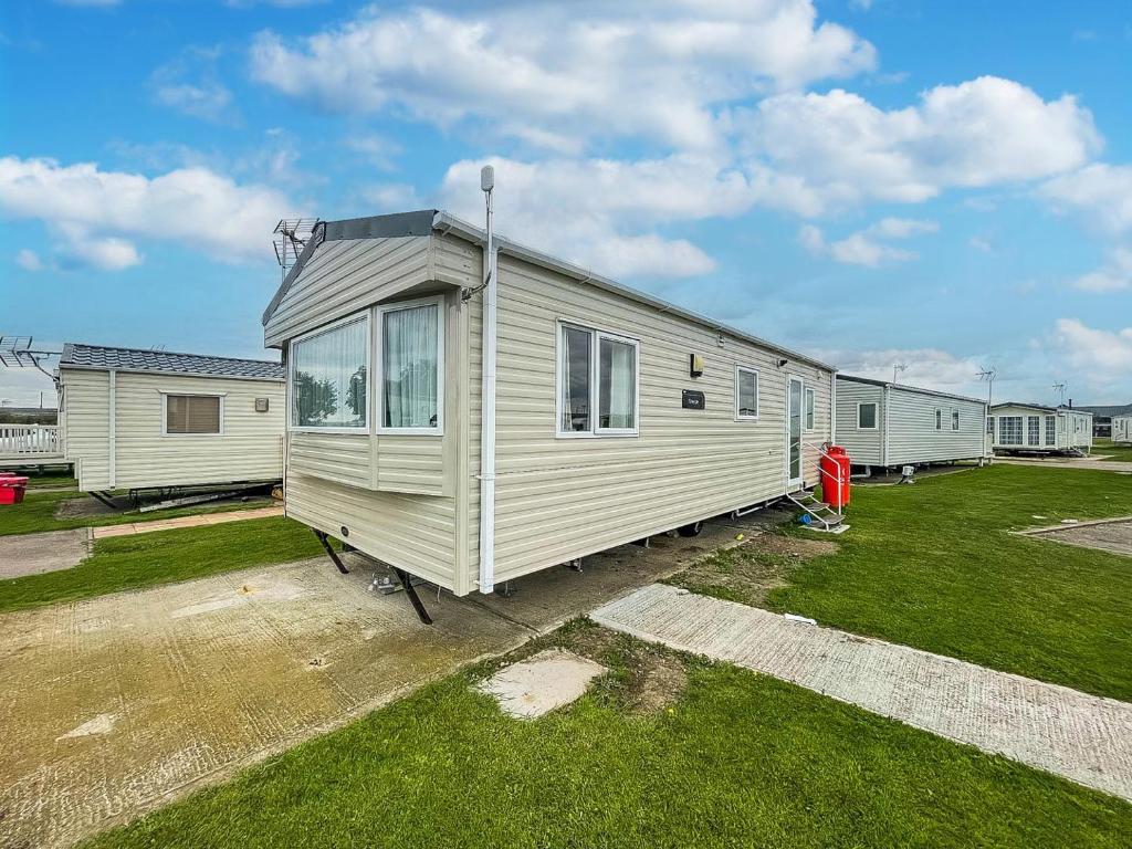 a tiny house is parked in a yard at Superb 6 Berth Caravan At Martello Beach, Near Clacton-on-sea Ref 29008mc in Clacton-on-Sea