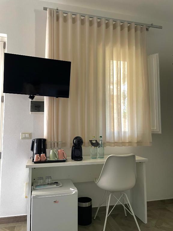 a white desk with a chair and a window at B&B SoleLuna in Lampedusa