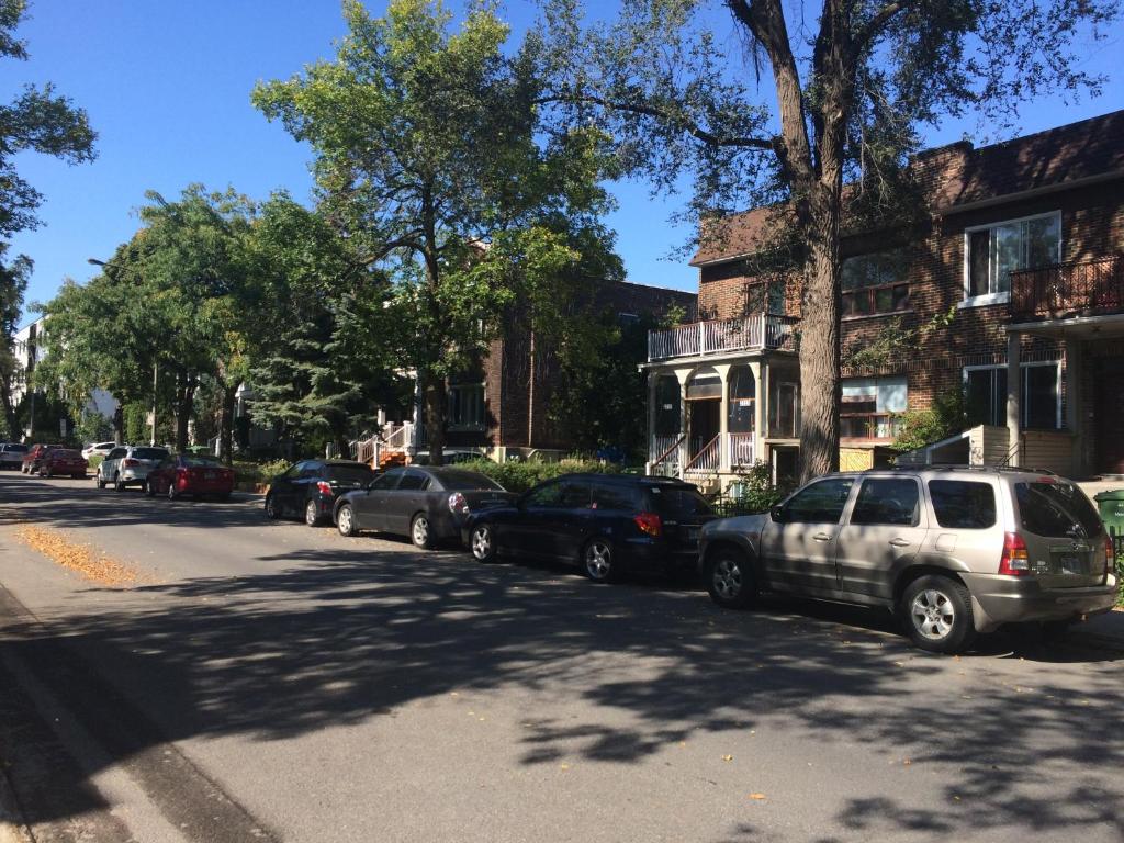 a row of cars parked on the side of a street at Maria Montreal in Montreal