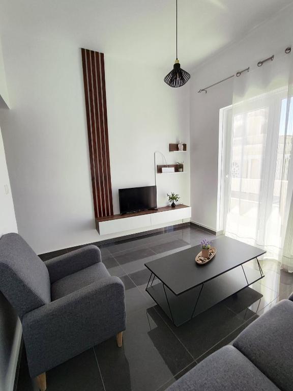a living room with a couch and a coffee table at Margarita in Chania