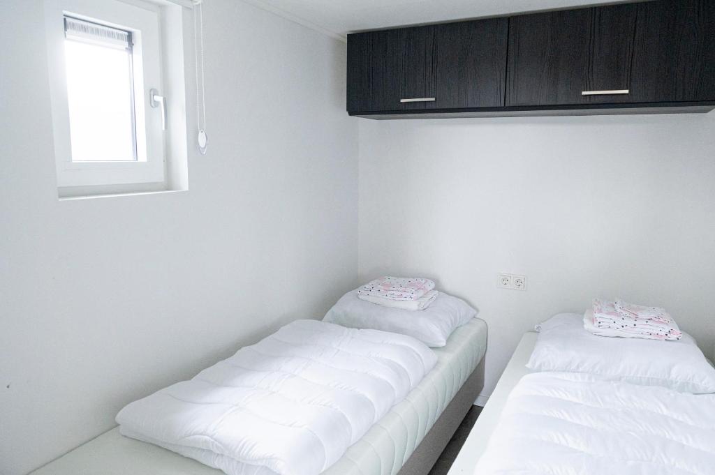 Postel nebo postele na pokoji v ubytování Camping de Konijnenberg Tiny House