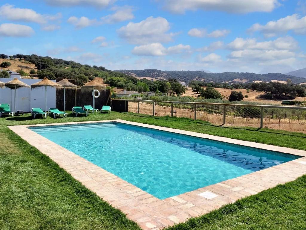 a swimming pool in the yard of a house at 7 bedrooms villa with private pool enclosed garden and wifi at Prado del Rey in Prado del Rey