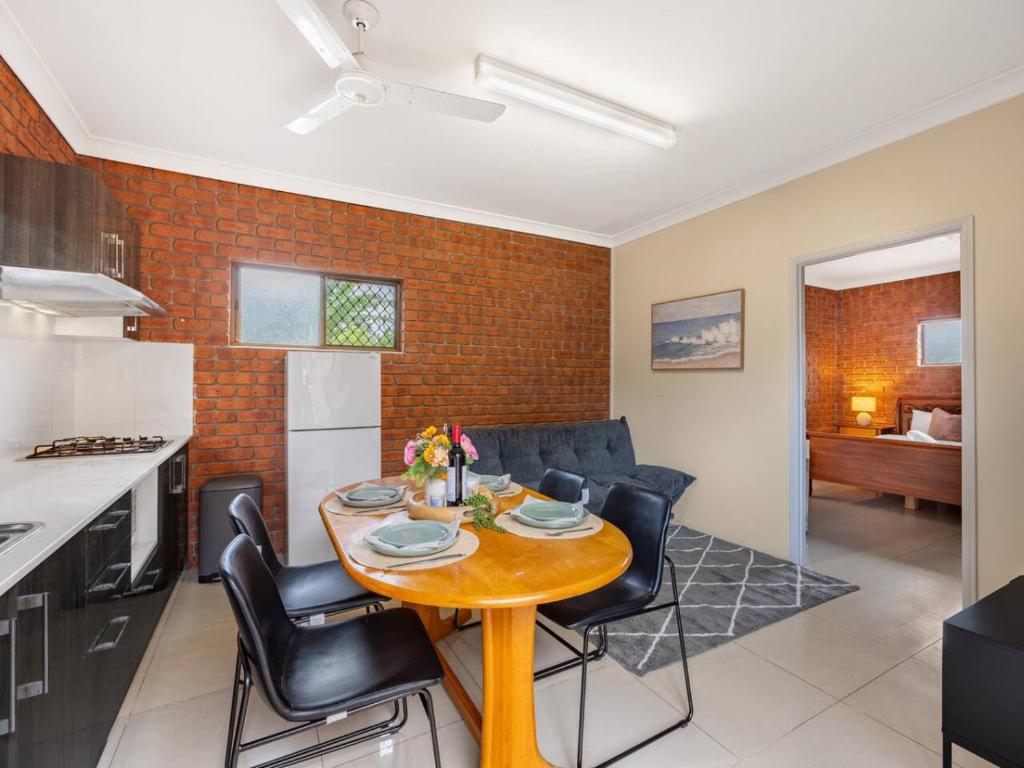 a kitchen and living room with a table and chairs at 1 Bedroom Comfy Unit Sleep 3 close to mall and bus in Brisbane