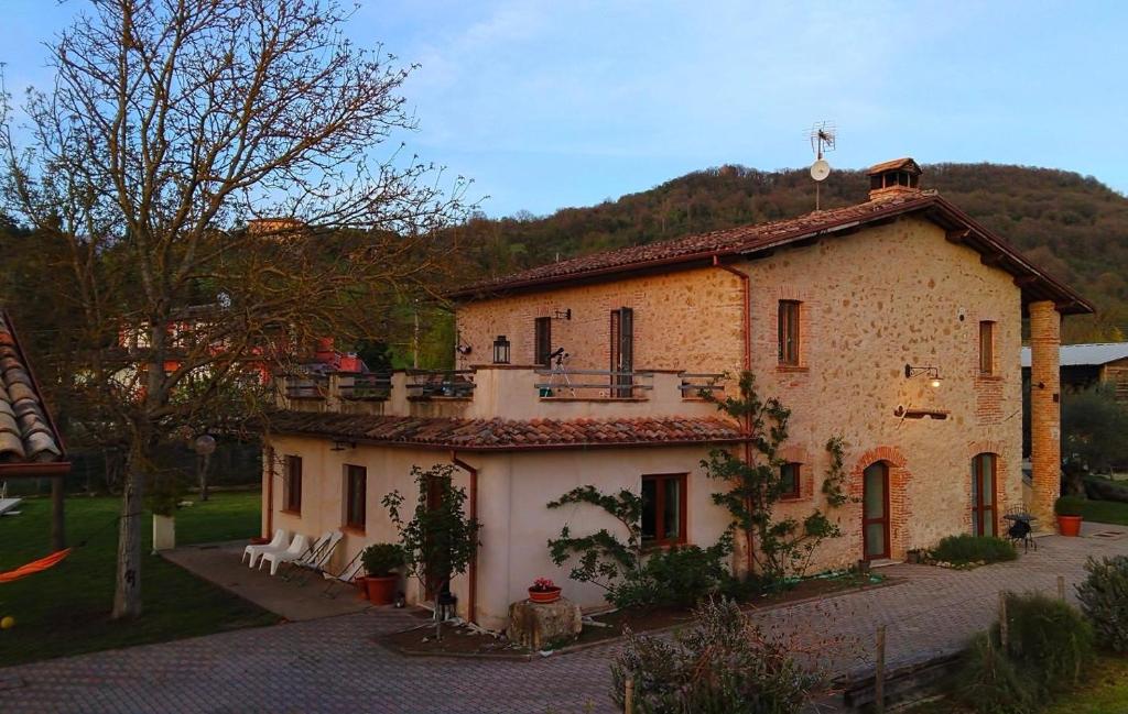 a large stone house with a balcony on top of it at Il Casale dei Nonni in Rieti