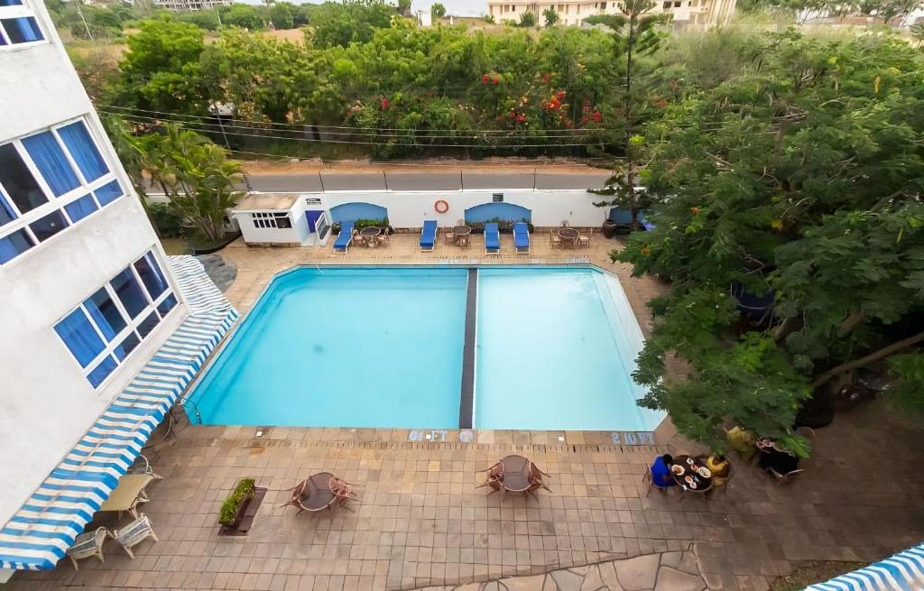 an overhead view of a swimming pool in a building at Ocean Blue Retreat-3 minute walk to Nyali Center and 3 minute walk to the Beach in Mombasa