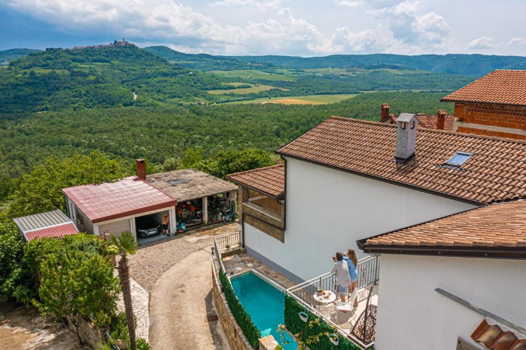 an aerial view of a house with a swimming pool at Holiday Home Belveder Motovun with heated pool in Livade