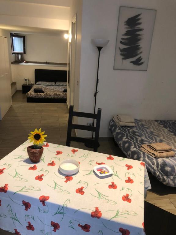 a room with a table with a flower pattern on it at San Damiano Suite in Catania