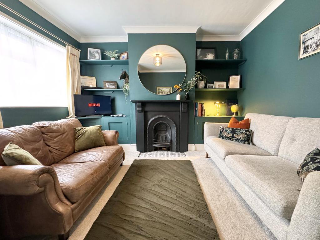 a living room with a couch and a fireplace at Stylish and Cosy stay in the Heart of Malton in Malton