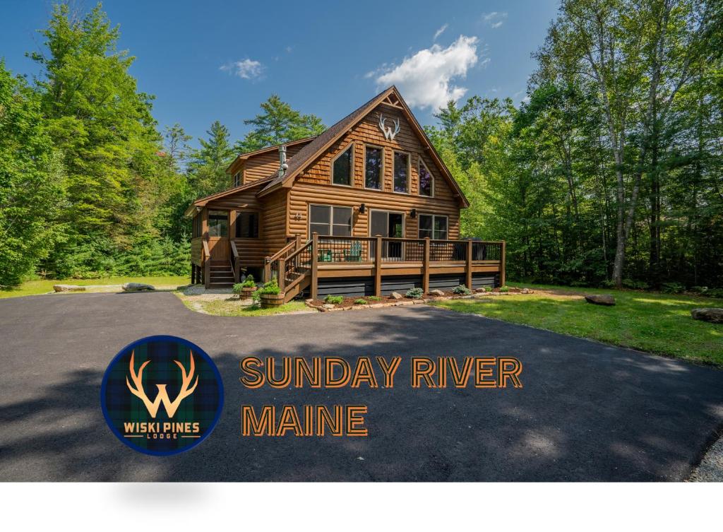 a log home with a sign in front of it at Ski Chalet 6 min to Sunday River - Hot Tub, Home Theater, Game Room, Fire Pit - Sleeps 12 in Bethel