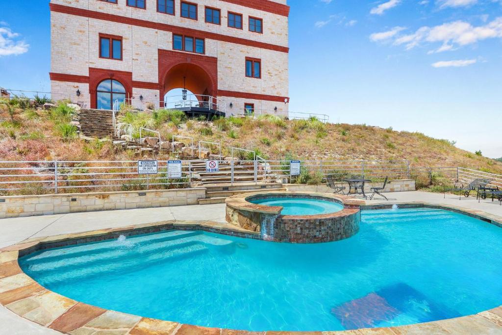 a pool in front of a building at Arc de Texas -Joan of Arc Suite in Johnson City