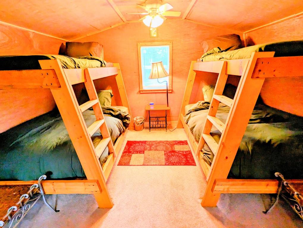 a room with three bunk beds in a house at Hidden Hollow Bed and Breakfast in Otto
