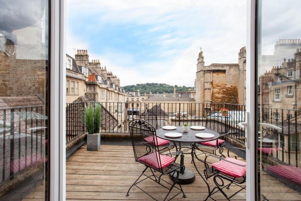 a patio with a table and chairs on a balcony at ※ Spacious, Central Bath Apartment ※ in Bath