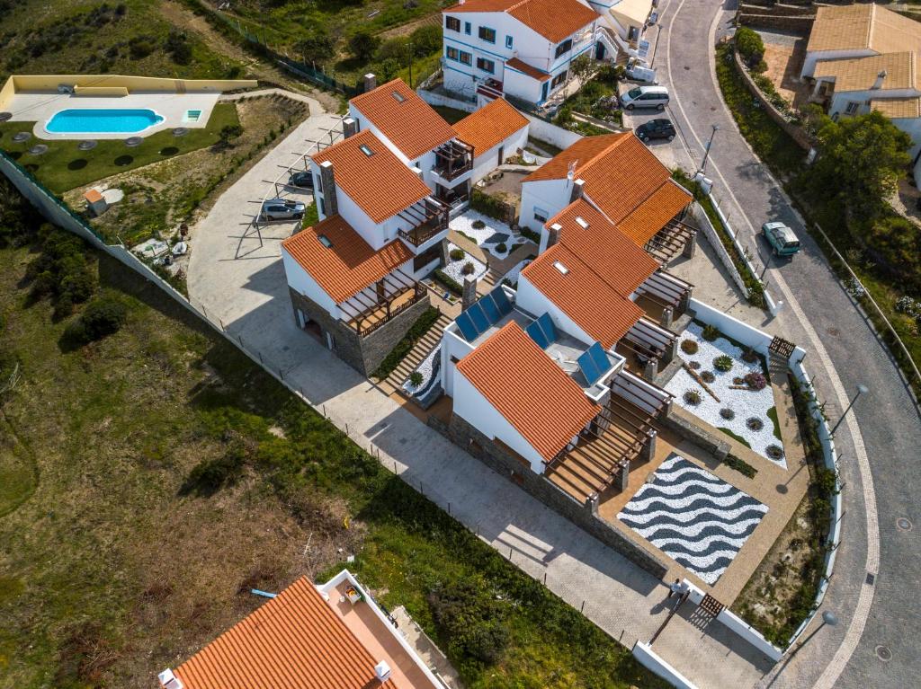 an aerial view of a house with a swimming pool at Falésias da Arrifana in Praia da Arrifana