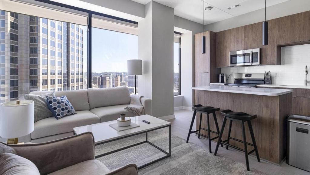 a living room with a couch and a kitchen at Landing at The 600 - 2 Bedrooms in Fountain Heights in Birmingham