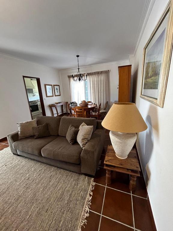 a living room with a couch and a table at Azenhas Apartment in Sintra
