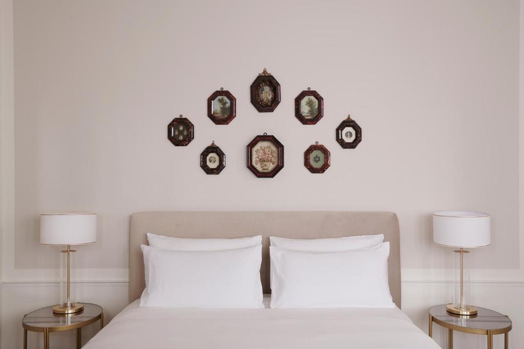 a bedroom with a bed and four plates on the wall at Violino d&#39;Oro Venezia in Venice