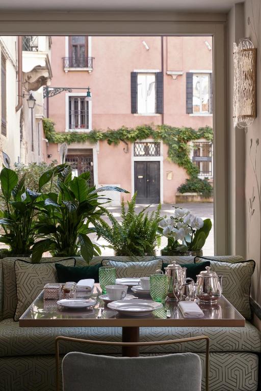 a table in a room with a large window at Violino d&#39;Oro Venezia in Venice