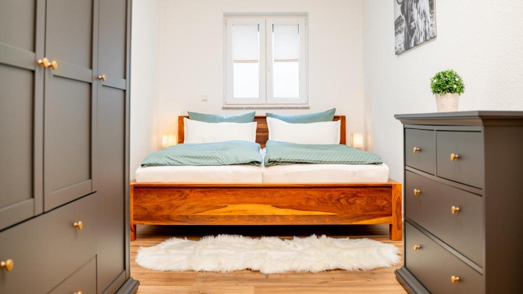 a bedroom with a bed with blue and white pillows at Altstadt I Glasfaser I Business I free parking in Quedlinburg