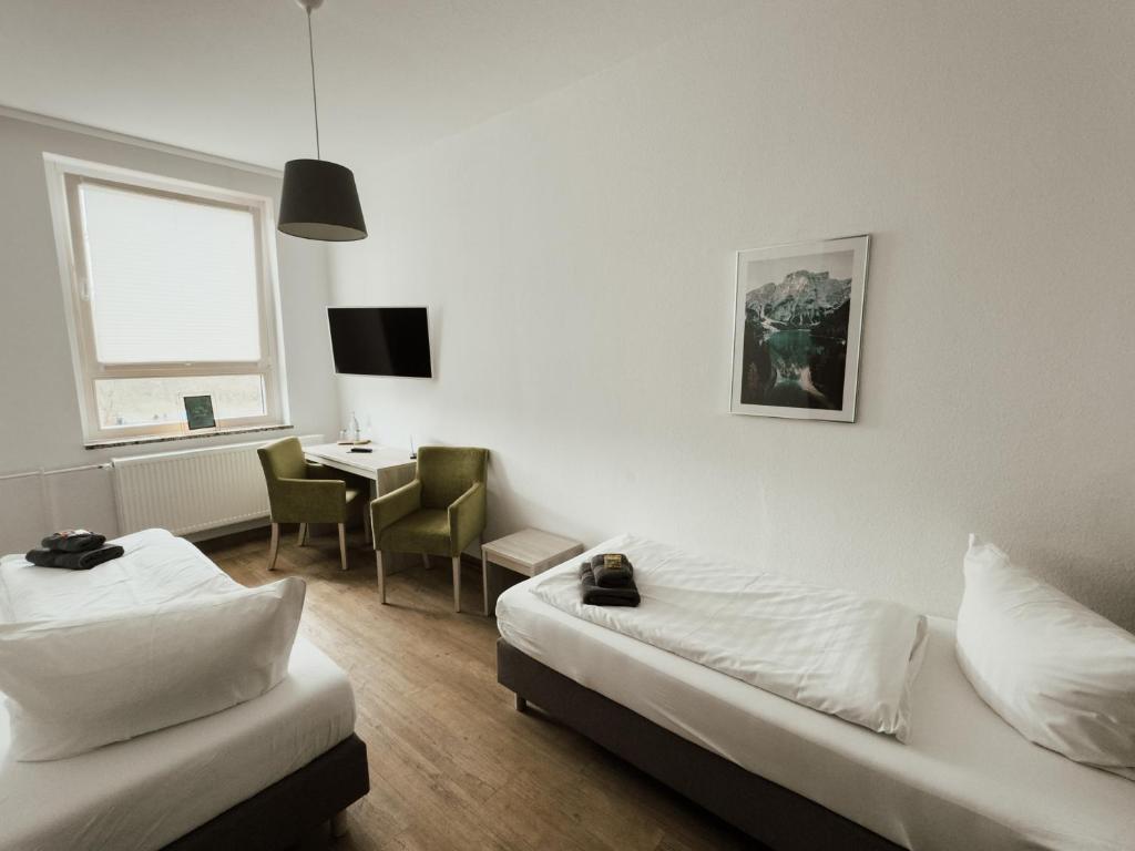 Postel nebo postele na pokoji v ubytování Hotel am Stadtpark Nordhausen