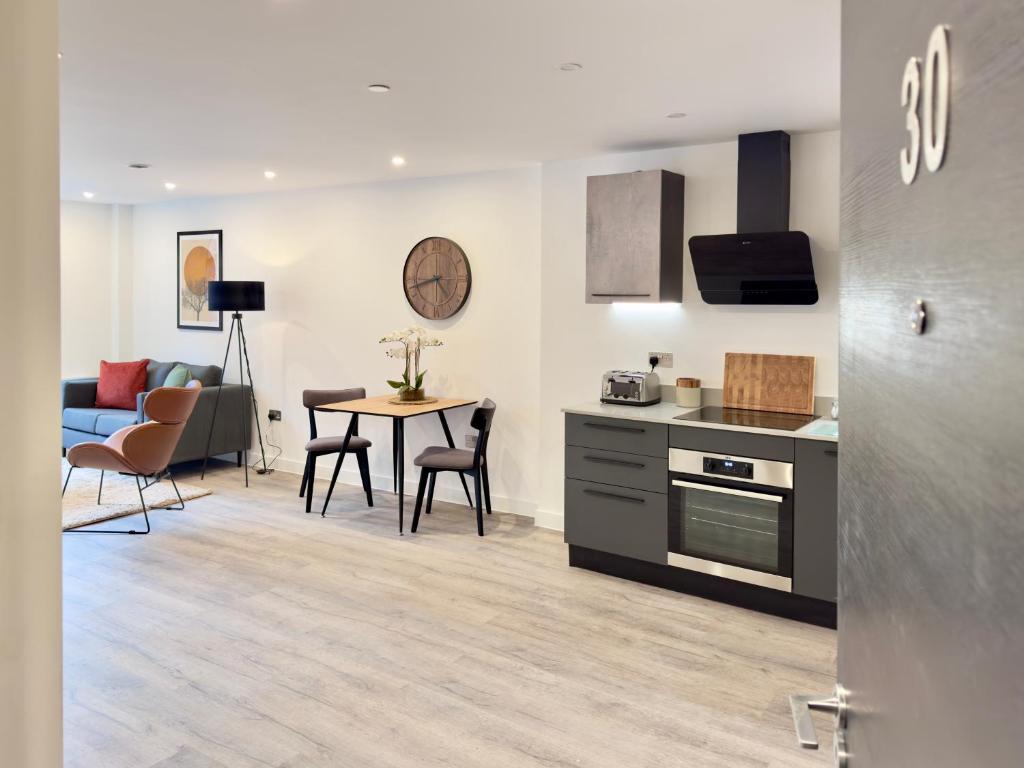 een keuken en een woonkamer met een tafel en stoelen bij Apartment 30 City gate in York