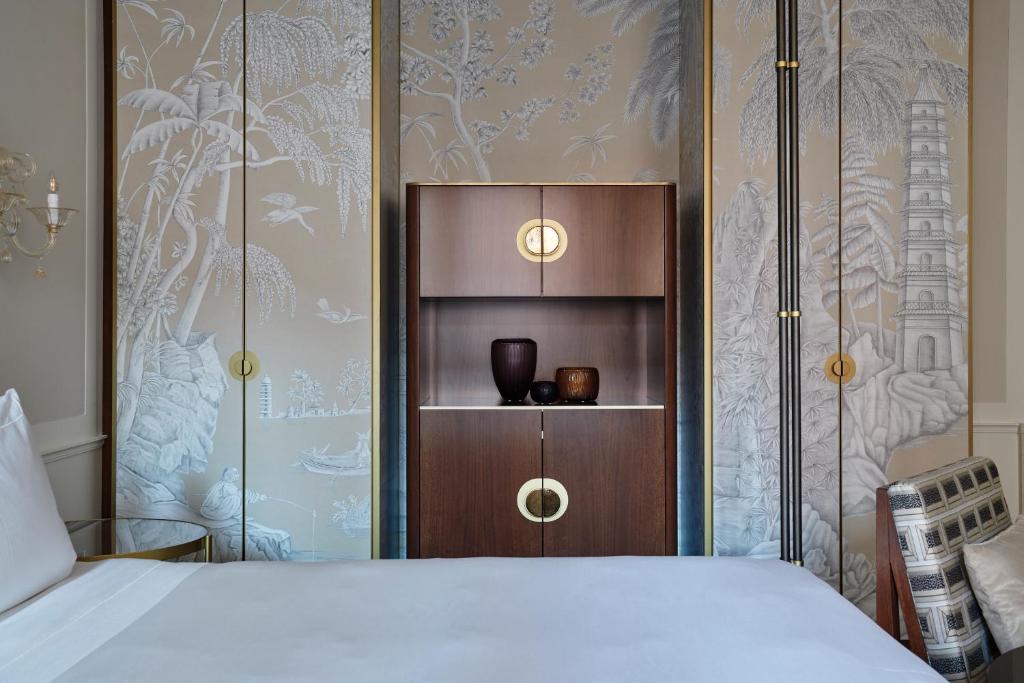 a bedroom with a bed and a wooden cabinet at Violino d&#39;Oro Venezia in Venice