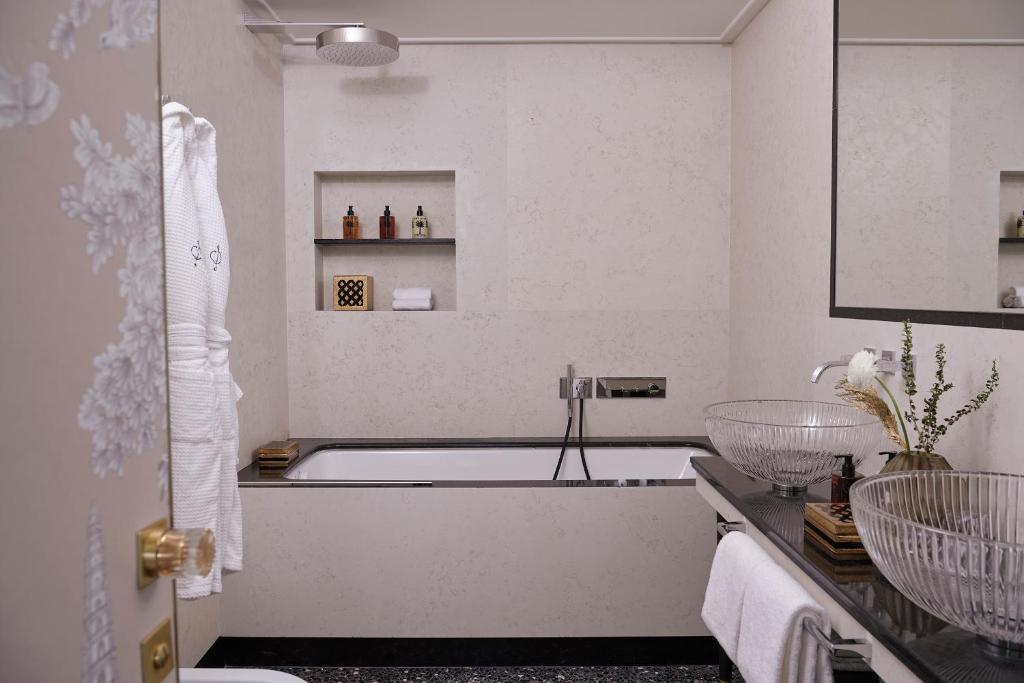 a white bathroom with a tub and a sink at Violino d&#39;Oro Venezia in Venice