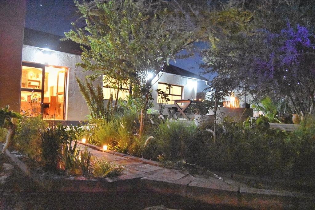 a house with a garden at night with lights at Knowhere Selfcatering Unit 2 in Omaruru