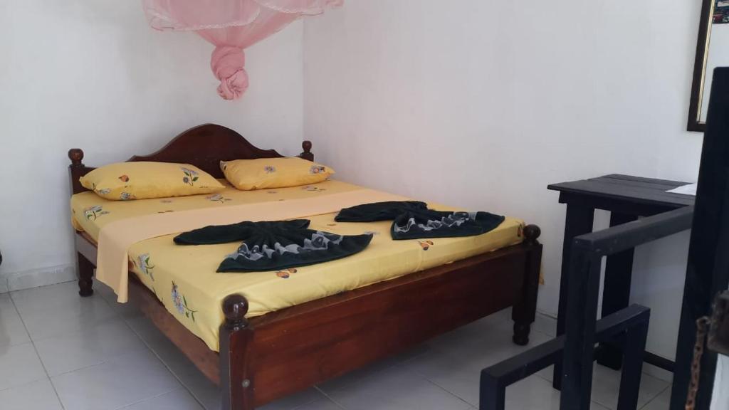 Postel nebo postele na pokoji v ubytování KANTHI GUEST INN