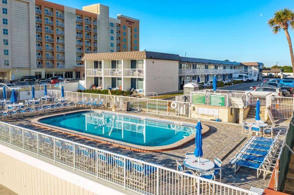 a swimming pool at a resort with chairs and a resort at Fantasy Island Resort I in Daytona Beach Shores