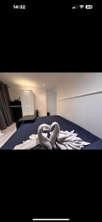 two swans sitting on a bed in a bedroom at Big Ben 15 minutes away in London