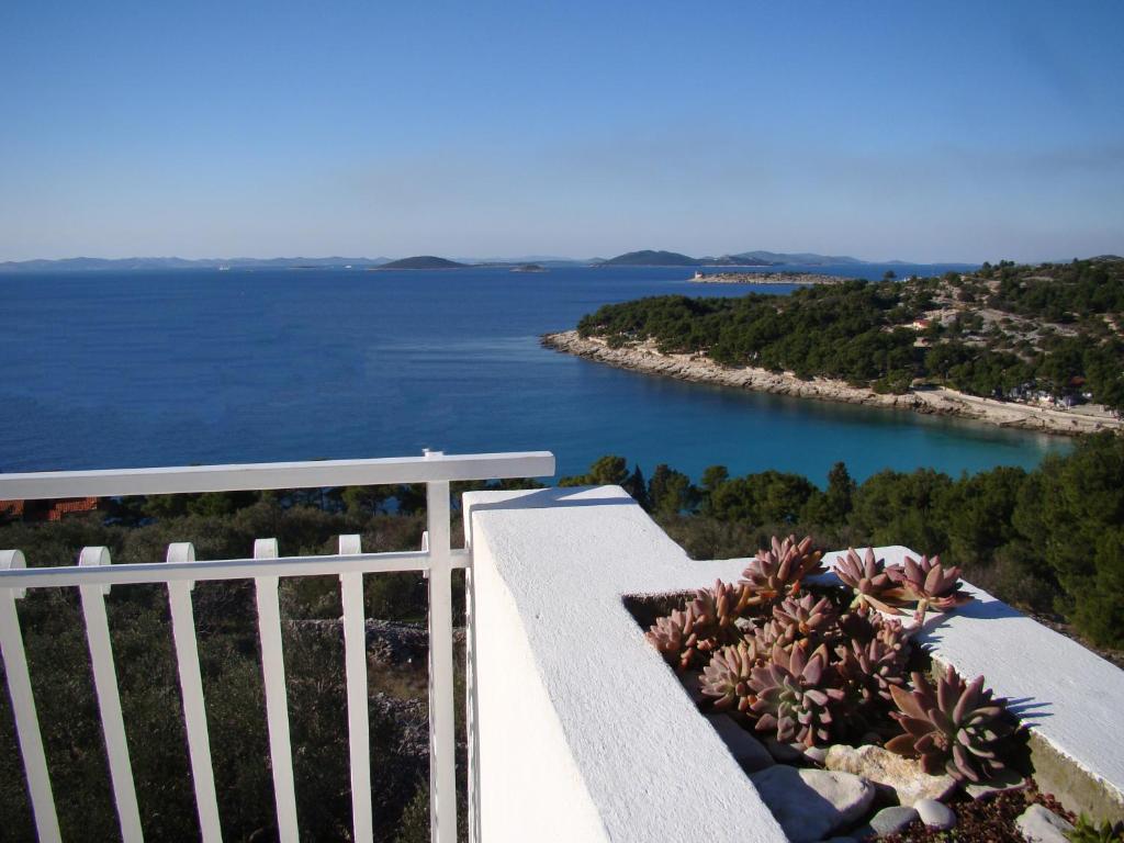 a balcony with a view of a body of water at Kornati Paradise Residence Slanica in Murter