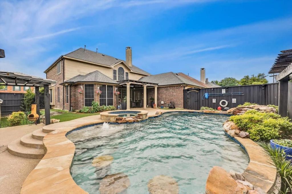 a swimming pool in the backyard of a house at Creekside Charm w Pool Backyard Oasis Patio in Plano
