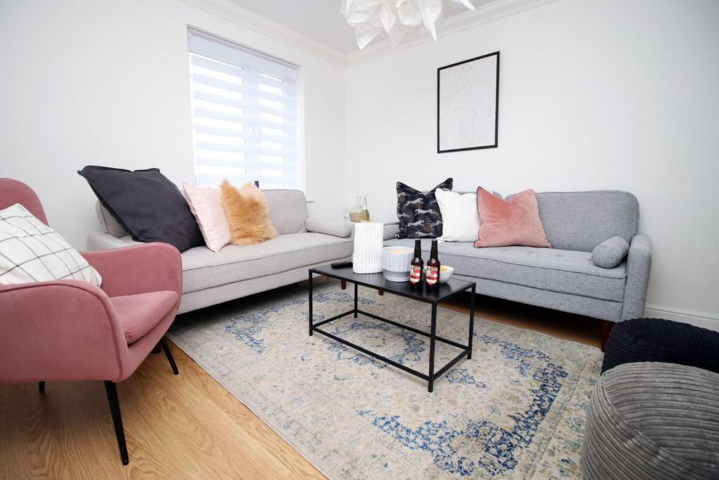 a living room with a couch and a table at 5 bedroom sleeps 10 | City Centre Newport in Newport