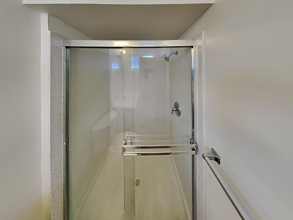 a shower with a glass door in a bathroom at San Jose Apartment in San Jose